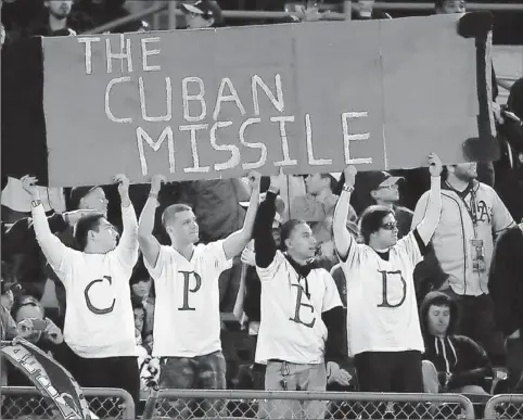  ?? By Kyle Terada, US Presswire ?? Gaining a following: Fans of the Athletics’ Yoenis Cespedes hold up a sign during an April 6 game in Oakland. The A’s hope Cespedes develops into the power hitter the club needs in the middle of its lineup. Cespedes’ power displays have made him a...