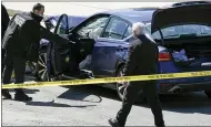  ?? AP PHOTO/J. SCOTT APPLEWHITE ?? U.S. Capitol Police officers stand near a car that crashed into a barrier on Capitol Hill in Washington on Friday.