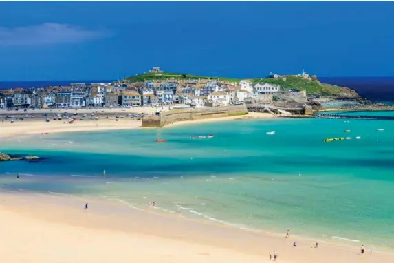  ?? (iStock) ?? Many more will be holidaying nearer home in places such as St Ives