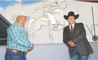  ?? DARREN MAKOWICHUK ?? Jim Laurendeau, left, vice-president of park planning and developmen­t for the Calgary Stampede. stands with Don Wilson, a member of the Stampede’s historical committee, outside the Corral.