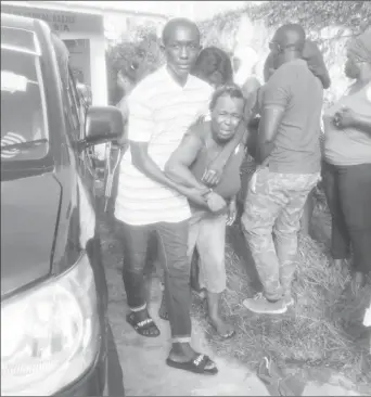  ??  ?? Ewart Reynolds wife, Rubina Taylor being consoled by a relative at the Mahaicony hospital yesterday.