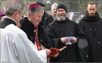  ??  ?? Bishop Smith performs the ceremony in the snow.