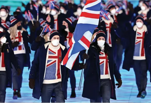  ?? Lintao Zhang/Getty Images ?? Skier Dave Ryding, left, and curler Eve Muirhead, right, lead the British team at the Winter Olympics opening ceremony in China yesterday