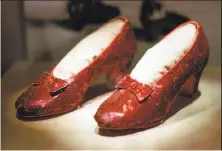  ?? Ed Zurga / Associated Press 1996 ?? The ruby slippers have been called “the Holy Grail of Hollywood memorabili­a.” The shoes were stolen in 2005 from the Judy Garland Museum in Grand Rapids, Minn.