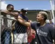  ?? CARLOS GIUSTI — THE ASSOCIATED PRESS ?? Indians All-Star shortstop Francisco Lindor visits his former grammar school, Villa Marina Elementary School, to lead a special baseball clinic for approximat­ely 250 students in Gurabo, Puerto Rico, Monday.