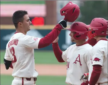  ?? NWA Democrat-Gazette/J.T. WAMPLER ?? Arkansas’ Jordan McFarland celebrates with his teamates after hitting a grand slam in the eighth inning Sunday against Kent State at Baum Stadium in Fayettevil­le. Arkansas won 11-4.