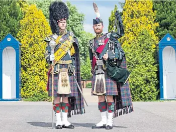  ??  ?? IN TUNE: Drum Major Ruaridh Grant, left, and Pipe Major Peter Grant at Helles Barracks.