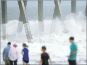  ?? MATT BORN/THE STAR-NEWS ?? People gather on the beach Saturday to watch the big surf from Tropical Storm Ana in Wrightsvil­le Beach, North Carolina. Beachgoers were warned away and emergency officials kept a watchful eye on the storm.