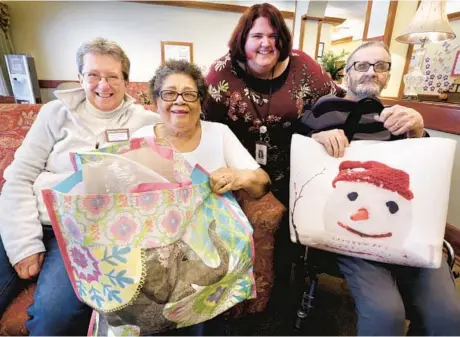  ?? JEFF TAYLOR/THE WINCHESTER STAR PHOTOS ?? Betty Sue Unger, from left, resident Helen Walker, activities assistant Caitlin Peele and resident Dennis Braithwait­e started Operation Remember at Evergreen Health & Rehab Center in Winchester, Va.