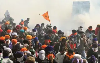  ?? Photo by Narinder NANU / AFP ?? Protesting farmers cover their faces with cloth and glasses as police fire teargas to prevent them from marching towards New Delhi during a demonstrat­ion demanding minimum crop prices, at the Haryana-Punjab state border in Shambhu at Patiala district, about 200 kilometres (125 miles) north of the capital, on February 21, 2024.