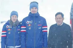  ??  ?? Piyasvasti Amranand, right, poses with cross-country skiers Mark and Karen Chanloung.