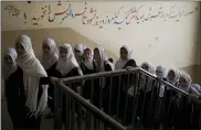  ?? AP PHOTO/FELIPE DANA ?? Girls walk upstairs Sunday as they enter a school before class in Kabul, Afghanista­n.