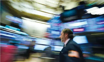  ??  ?? Traders work on the floor at the closing bell of the Dow Industrial Average at the New York stock exchange on Wednesday. Photograph: Bryan R Smith/AFP via Getty Images