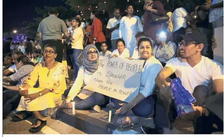  ??  ?? Voicing their thoughts: Pro-democratic Sri Lankans taking part in a candle light vigil, in Colombo. — AP