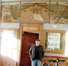  ?? Marc Hayot/Herald Leader ?? Rick Parker stands in front of the old postmaster’s office in the Phat Tire building. Above Parker is the mural that he cleaned for the city.