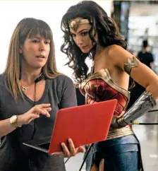  ??  ?? Bottom: Director Patty Jenkins and Gadot check their progress on set.