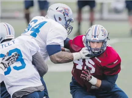  ?? DARIO AYALA/MONTREAL GAZETTE ?? Brian Brikowski, right, participat­es in pass-rush drills at the Alouettes’ training camp at Bishop’s University in Lennoxvill­e on Sunday. He is hoping to earn a rush end job after a solid 2014 CFL debut with three sacks in six games.