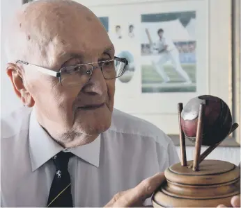  ??  ?? Tom with the ball which was presented to him after he caught five wickets off Len’s bowling.