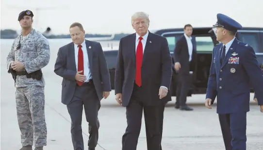  ?? AP PHOTO ?? STILL FIGHTING: President Trump walks to his motorcade vehicle as he arrives on Air Force One yesterday at Andrews Air Force Base en route to Washington after he returned from Trump National Golf Club in Bedminster, N.J.