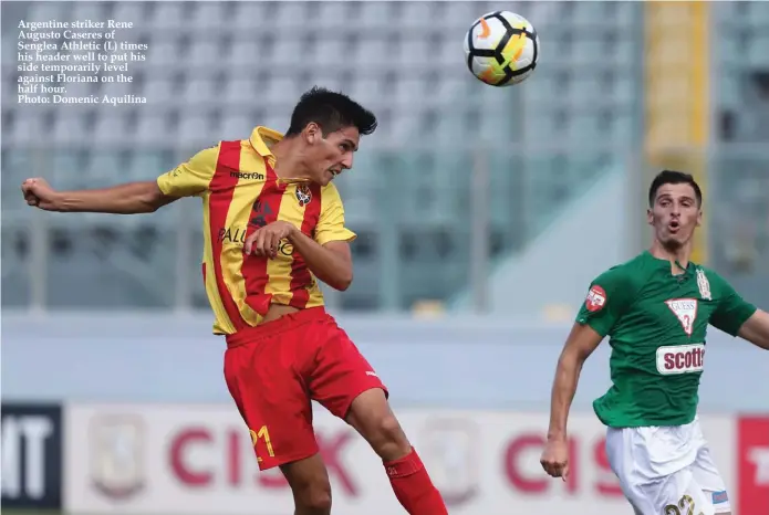  ??  ?? Argentine striker Rene Augusto Caseres of Senglea Athletic (L) times his header well to put his side temporaril­y level against Floriana on the half hour. Photo: Domenic Aquilina