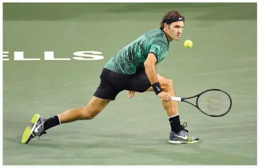  ??  ?? Roger Federer returns a shot to Stephane Robert at the BNP Paribas Open Tennis Tournament in Indian Wells, California, on Sunday. (AP)