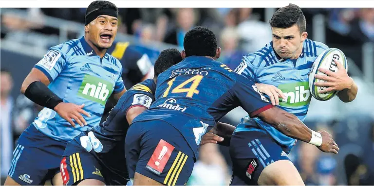  ?? Picture / Getty Images ?? Blues tryscorer Bryn Gatland, supported by halfback and captain Augustine Pulu, fends off Highlander­s wing Waisake Naholo during their Super Rugby match at Forsyth Barr Stadium in Dunedin last night.