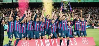  ?? ?? Barcelona players celebrate as captain Sergio Busquets lifts the La Liga trophy at Camp Nou on Saturday