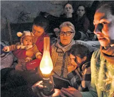 ?? ?? Dark times: civilians huddle in a bomb shelter in Mariupol, south-eastern Ukraine
