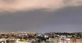  ?? AMIR COHEN/REUTERS ?? An anti-missile system operates Sunday, as seen from Ashkelon, Israel, after Iran launched some 300 drones and missiles toward Israel on Saturday.