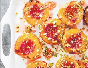  ?? JOE KELLER/AMERICA’S TEST KITCHEN VIA AP ?? Honey glazed roasted peaches. This recipe appears in the cookbook “How to Roast Everything.”