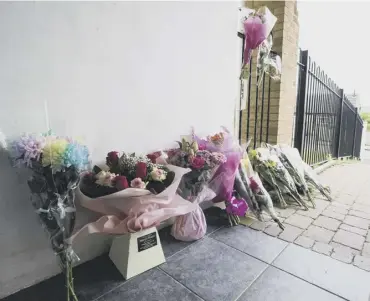  ??  ?? SCENE: Tributes left for 23-year-old Paige Gibson killed in Cumberland Close, Ovenden, Halifax