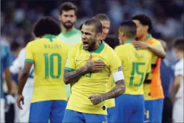  ?? VICTOR R. CAIVANO — THE ASSOCIATED PRESS ?? Brazil’s Dani Alves celebrates his team’s 2-0 victory over Argentina at the end of their Copa America semifinal soccer match at Mineirao stadium in Belo Horizonte, Brazil Tuesday.