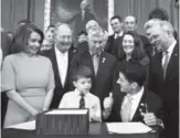  ?? Cliff Owen, The Associated Press ?? Speaker Paul Ryan gives a thumbs-up to Max Schill, 7, who suffers from Noonan Syndrome, after signing the 21st Century Cures Act last Thursday. Rep. Diana DeGette of Colorado, second from right, was a sponsor of the bill.