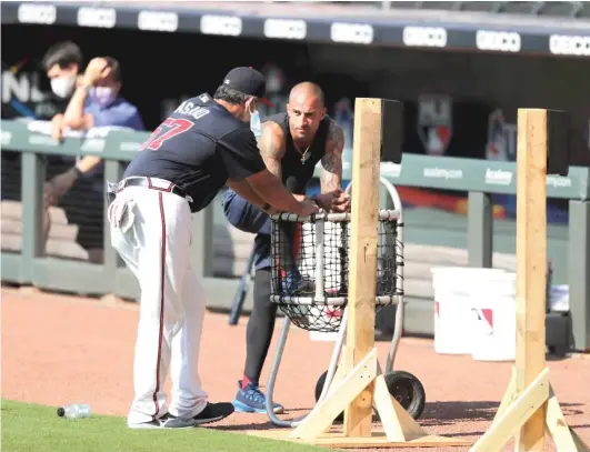  ?? BRYNN ANDERSON/AP ?? The Braves’ Nick Markakis (right, at camp Sunday) opted out of the season Monday. Teammate Freddie Freeman (not pictured) is battling COVID-19.