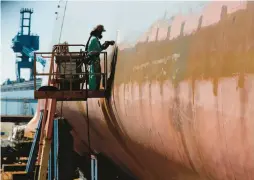  ?? ROBERT F. BUKATY/AP 2018 ?? A welder works on the hull of a Zumwalt-class destroyer in the shipyard at Bath Iron Works in Bath, Maine.