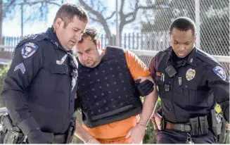  ?? (Photo by Logan Kirkland, SDN) ?? Capital murder suspect Tommy Chisholm, of Kosciusko, is escorted by Starkville Police officers to his initial appearance in Starkville Municipal Court on Thursday.