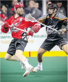  ?? AL CHAREST ?? Calgary Roughnecks’ star Curtis Dickson, left, made his return to the lineup Saturday after signing a three-year contract with the NLL team, however, the New England Black Wolves spoiled the return with a 16-10 victory.