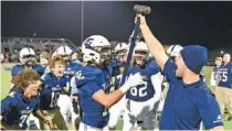  ?? STAFF PHOTO BY MATT HAMILTON ?? Gordon Lee defensive end coach Evan Fraley, right, presents a sledgehamm­er to Ryan Swaney during Friday night’s GHSA Class A public playoff game against Georgia Military College Prep. Swaney hit a GMC Prep player as he attempted a catch on third down, causing an incompleti­on that led the Bulldogs to punt.