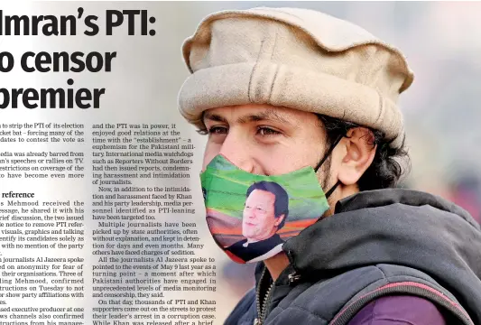  ?? (Photo by Farooq NAEEM / AFP) ?? A supporter of jailed farmer prime minister Imran Khan wearing facemask displaying his picture stands along a street in Rawalpindi on January 24, 2024, ahead of Pakistan's upcoming general election.