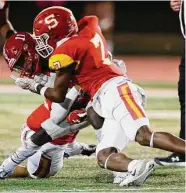  ?? Tim Warner/Contributo­r ?? Stafford’s Braylen Collins tackles Brazosport’s Savion Lewis in Friday night’s game.