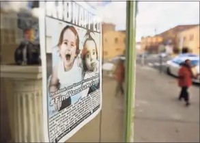  ?? Brian A. Pounds / Hearst Connecticu­t Media file photo ?? Flyers alerting the public to the hunt for missing toddler Vanessa Morales still hang in windows of Main Street Ansonia businesses on Dec. 1, 2020, the one-year anniversar­y of her disappeara­nce from her Ansonia home.