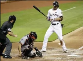  ?? LYNNE SLADKY — THE ASSOCIATED PRESS ?? Miami’s Giancarlo Stanton, right, is hit by a pitch thrown by San Francisco’s Matt Cain during the second inning Wednesday in Miami. At left is home plate umpire Nick Mahrley (48) and center, Giants catcher Nick Hundley.