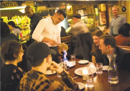  ?? Vivian Johnson / Special to The Chronicle ?? Table-side service at Le P’tit Laurent in Glen Park is just one of the many reasons it has remained a neighborho­od favorite.