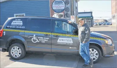  ?? KATIE SMITH/JOURNAL PIONEER ?? Myles Doucette, manager of United Summerside Taxi Inc., shows off one of the company’s wheelchair accessible vans outside the taxi stand April 10.