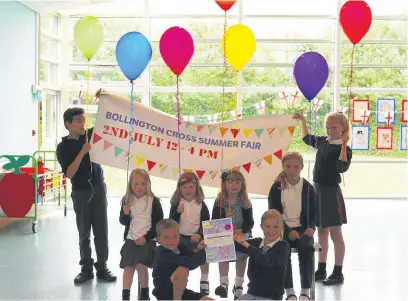  ??  ?? ●● Bollington Cross Primary School pupils with real balloons to symbolise their virtual balloon race ahead of the school’s summer fair