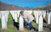  ??  ?? A woman kisses a relative's grave at the memorial centre of Potocari, near the Bosnian city of Srebrenica.