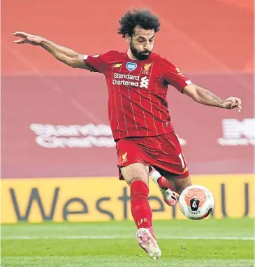  ?? AFP ?? Liverpool’s Mohamed Salah scores a goal during a Premier League game at Anfield this season.