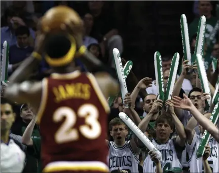  ?? CHARLES KRUPA - THE ASSOCIATED PRESS ?? FILE - In this May 7, 2010, file photo, Boston Celtics fans try to distract Cleveland Cavaliers forward Lebron James (23) while he shoots foul shots during the first quarter of Game 3 in the second round of an NBA basketball playoff series in Boston. When the virus wanes enough to allow the games to begin again, the very essence of these events will likely be missing. Playing in empty buildings would require a significan­t recalibrat­ion.