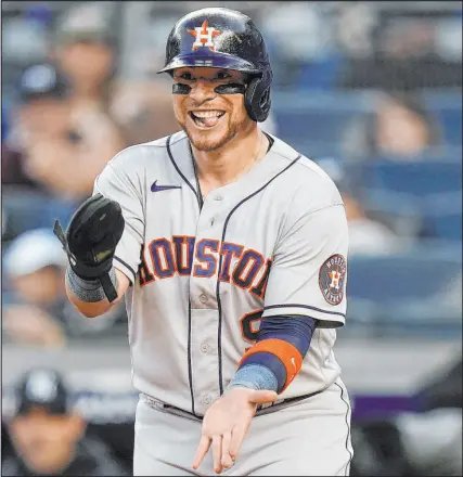  ?? Seth Wenig The Associated Press ?? Houston’s Christian Vazquez celebrates Saturday as Chas Mccormick rounds the bases after hitting a two-run home run at Yankee Stadium. The Astros will go for the ALCS sweep on Sunday.