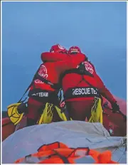  ??  ?? Alberto Agrelo and Alejandro Samper, rescuers with the Spanish NGO Open Arms, embrace in a gesture of encouragem­ent as they prepare for a rescue on a dingy in the Mediterran­ean Sea.